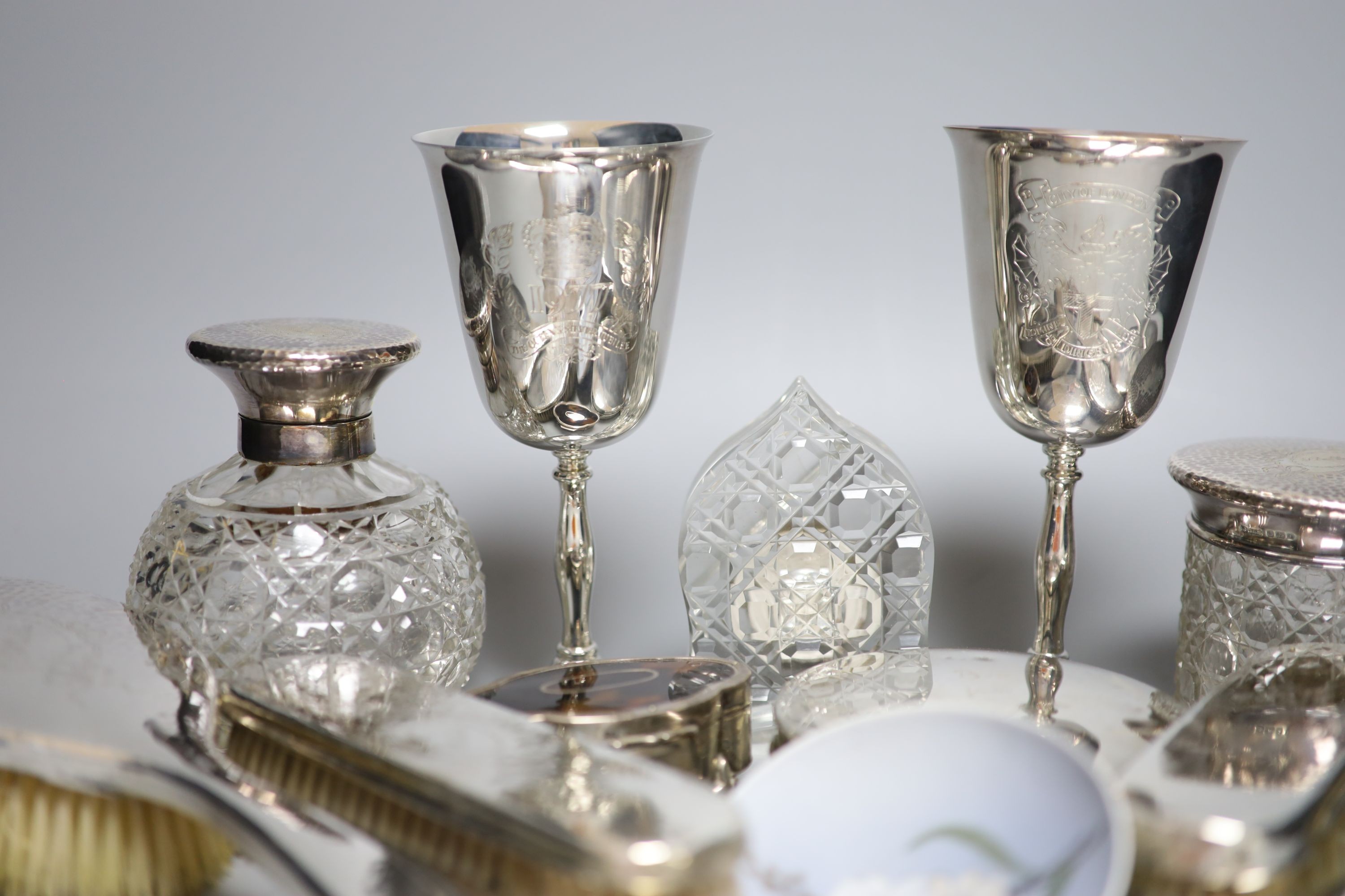 A George V hammered silver ten piece dressing table set with tray, engraved 'Stella' and six other items including a silver circular powder box?, a tortoiseshell mounted trinket box and two plate goblets.